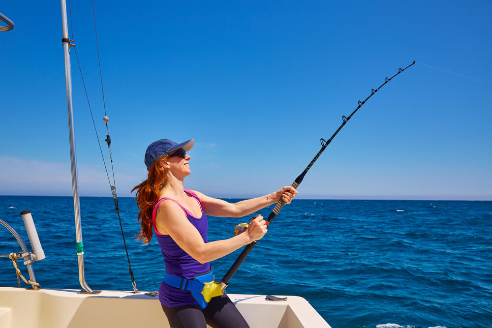 A woman is casting her line at one of the best fishing spots in Panama City Beach.