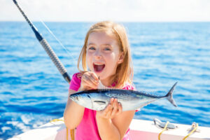 A little girl fishing, one of the top 30A activities.
