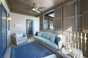 The porch area of a 30A vacation rental to relax with a drink from a local coffee shop.
